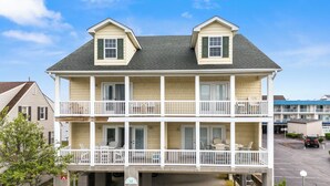 A two-story building with a balcony on the ground floor and a second-floor balcony.