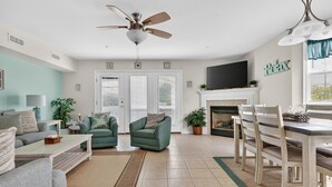 A living room with a sofa, armchair, coffee table, and a fireplace.