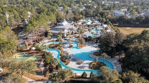 An aerial view of a resort with a large swimming pool, multiple buildings, and surrounding greenery. - Newly Remodeled 5 Br! | Watercolor Resort Access | Walk To Pool | Golf Cart! (Santa Rosa Beach)