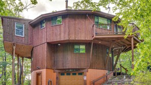 A multi-level wooden cabin with a garage, a balcony, and a staircase leading to an upper deck. - Dock & Beach Access: Scenic Lake Ossipee Cabin! (Center Ossipee)