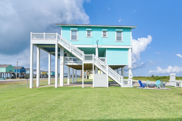 A two-story house with a balcony and a staircase.