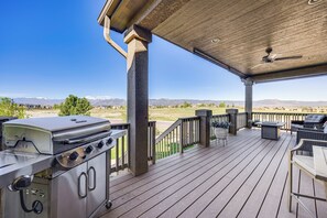 A covered outdoor deck with a barbecue grill, seating area, and a view of mountains. - Mtn-view Paradise Near Usafa in Colorado Springs! (Colorado Springs)
