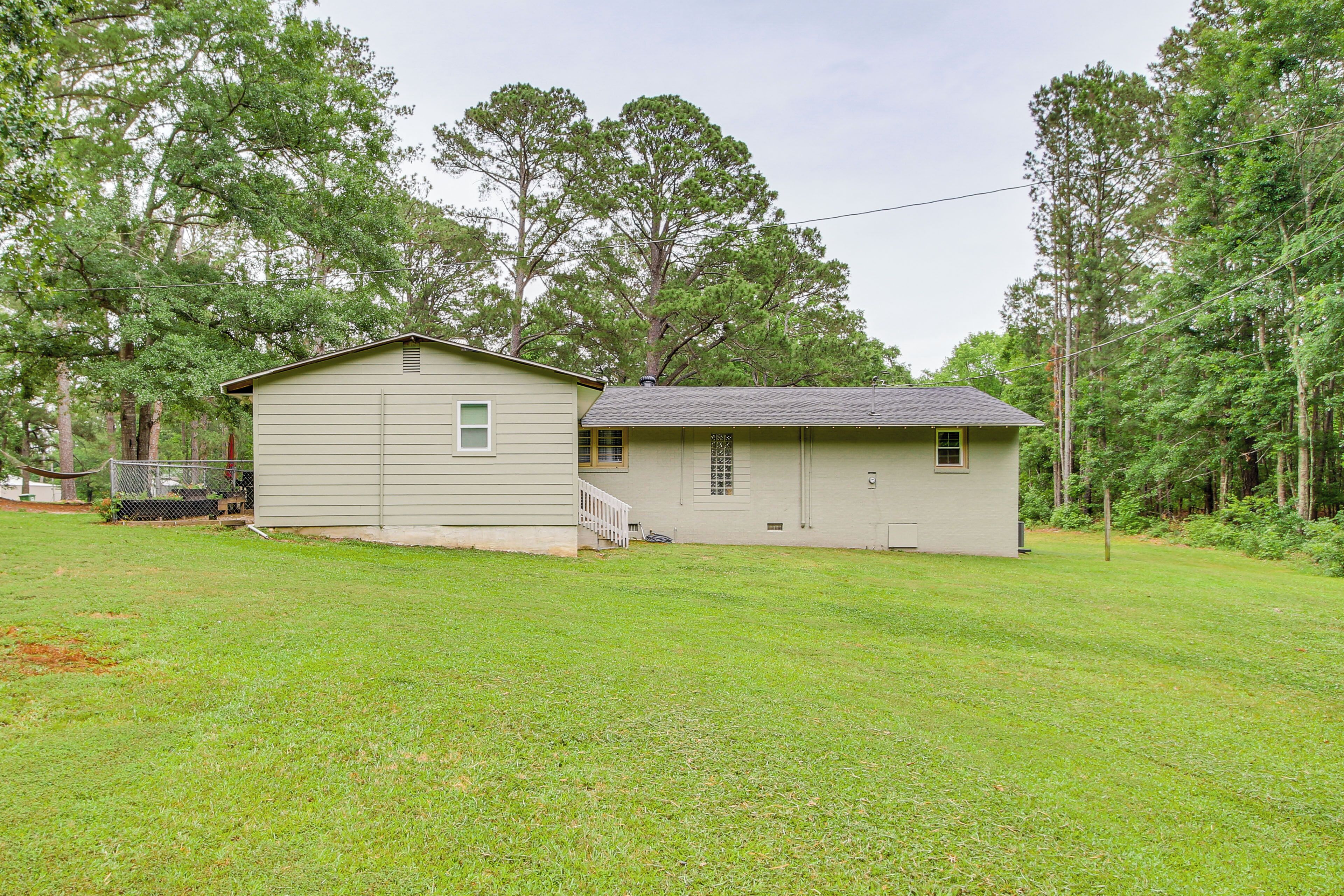 A two-story house with a covered porch and a small attached garage.