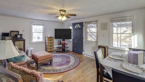 A living room with a television, a dining table set for four, and a ceiling fan. - 3 Mi to Englewood Dam: Pet-friendly Home w/ Yard! (Englewood)