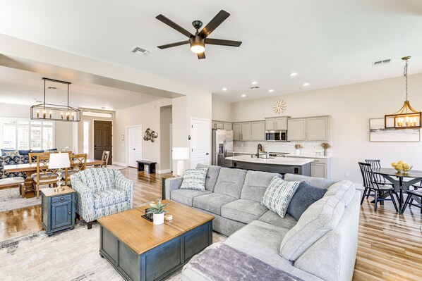 Relax in this inviting living area with a sofa, coffee table, and armchair.