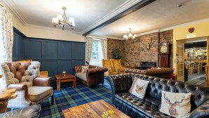 A traditional interior with a fireplace, leather sofas, and a bar area. - Bein Inn hotel  (Perth)