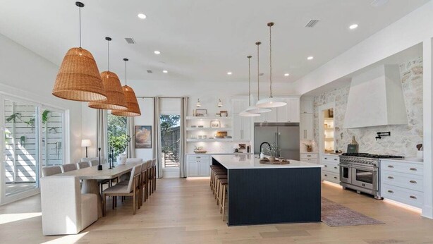 A modern kitchen with a central island, pendant lighting, and a stone backsplash. - Sleeps 20! Rooftop GULF VIEWS, Private Pool, LSV/golf cart, Bikes, 2 Kitchens! Pet Friendly! (Santa Rosa Beach)