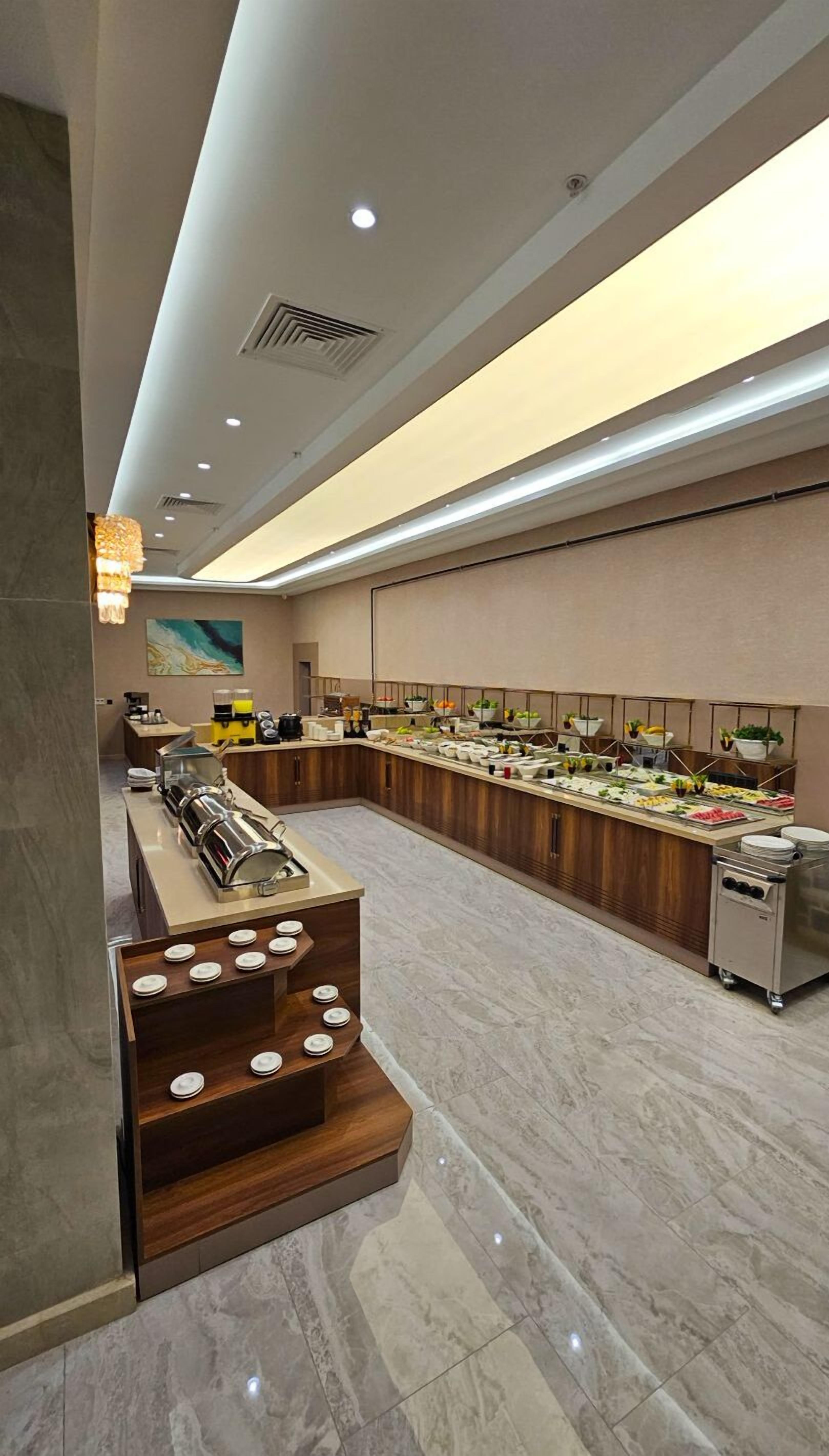 A modern buffet setup with a variety of food items and a coffee station.