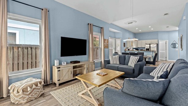 A modern living room with a flat-screen TV, a wooden coffee table, and a grey sofa set. - Serenity Now-Free Golf Cart-Hot Tub-Comm Pool (Destin)