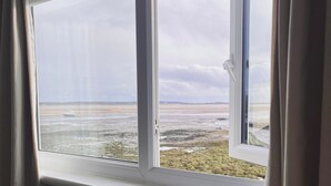 A room with a large window overlooking a coastal landscape. - Natterjack Cottage - Access to the Western Lakes (Millom)