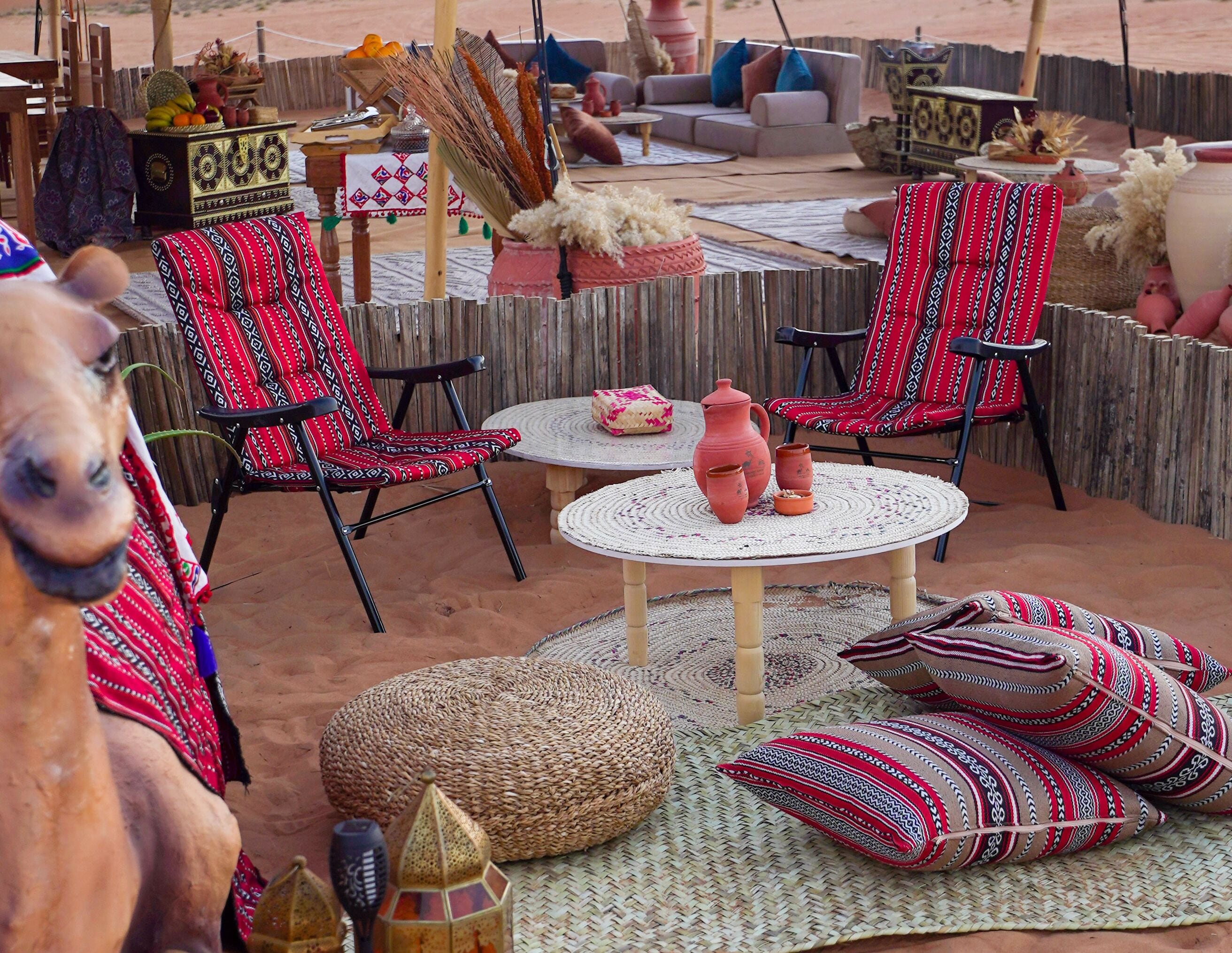 A cozy outdoor seating area with patterned chairs, a round table, and woven cushions.