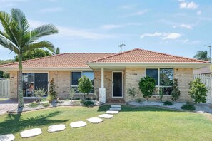 Front lawn with stepping-stone path and palms - Urban Getaway Bargara Central (Bargara)