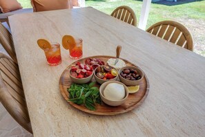 Outdoor dining table set with a grazing platter - Urban Getaway Bargara Central (Bargara)