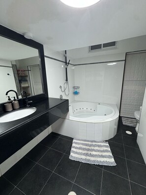 Jetted bath, towels, soap, toilet paper