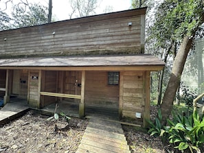 A rustic wooden building with a covered porch and a door marked '304.' - Convenient, Clean, Cozy, Cheap 5 (Tallahassee)