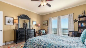 A bedroom with a bed, dresser, and a large window with a view of the ocean. - "Wahoo" Gulf Beachfront, 4 Bedroom/4 Bath, Sleeps 14, Pet Friendly, Cargo Lift (Dauphin Island)