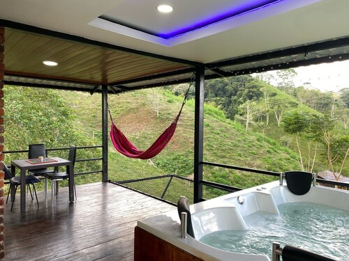 Cabin in Norcasia Jacuzzi, spring water pool and extreme attractions option.