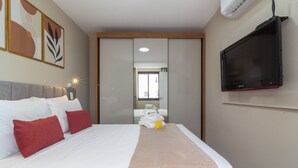 A hotel room with a bed, a TV, and a view of the outside. - Close to Rio's city center | IM712 (Rio de Janeiro)