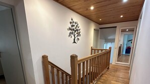 A wooden staircase with a railing, a wall-mounted tree decoration, and a wooden floor. - House by the river. Near Sarlat, Beynac, La Roque Gageac (Vézac)
