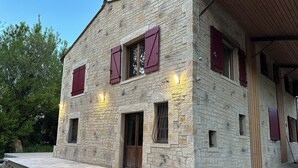 A stone building with a wooden door and windows with shutters. - House by the river. Near Sarlat, Beynac, La Roque Gageac (Vézac)