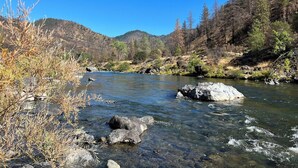 A clear river with rocks, surrounded by hills and sparse vegetation. - Private 1-bedroom 1-bathroom guest suite in the forested area of Trinity County. (Big Bar)
