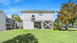 A single-story house with a covered porch and a small deck.