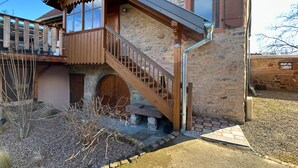 A traditional stone house with a wooden staircase leading to a balcony. - La P'tite Maison - Authentic stay on the Wine Route (Orschwihr)
