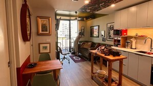 A compact living space with a dining area, a kitchen, and a seating area.
