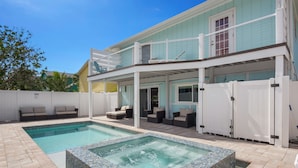 A two-story house with a swimming pool and a hot tub. - 🏖️Private Pool, Steps to Beach-Times Square District-Lazy Lobster🦞 (Fort Myers Beach)