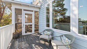 A covered porch with two chairs and a potted plant. - Close to 2 Beach Accesses, Resort Pool, Bikes, Gulf View (Inlet Beach)