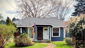 A house with a blue exterior, a grey roof, and a brick pathway leading to the front door. - Welcome to your private Ballard retreat! (Seattle)