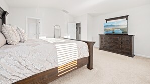 A bedroom with a large bed, a dresser, and a flat-screen TV on a stand. - Clemson University (6 min) - 1kMbps Internet - Easy Check In - Office Space (Pendleton)