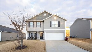A two-story residential house with a garage, a small front yard, and a tree. - Clemson University (6 min) - 1kMbps Internet - Easy Check In - Office Space (Pendleton)