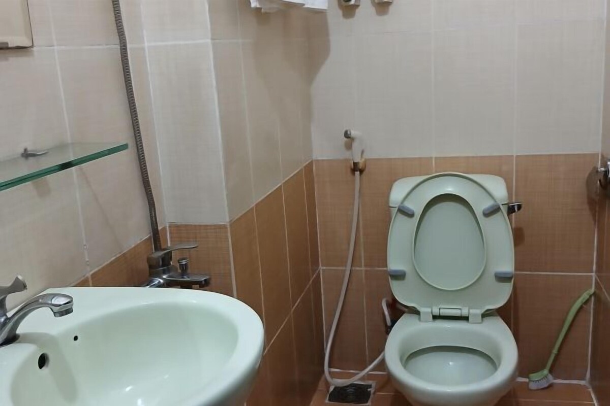 A bathroom with a toilet, sink, and shower.