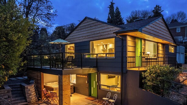 A two-story house with a balcony, a hot tub, and a covered patio area. - Luxury Spa, Patio, Deck & Views of Puget Sound in the Heart of Old Town, Tacoma (Tacoma)