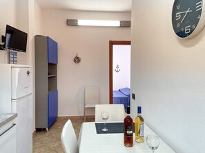 Enjoy a convenient stay with a kitchenette, dining table, and comfortable seating for two.