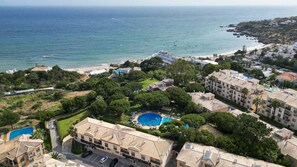 A coastal residential area with a swimming pool, beachfront, and multiple buildings. - #274 Pedra dos Bicos T by Home Holidays (Albufeira)