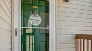 A door with a sign reading "Welcome to Chickadee Corner." - Charming 2-bedroom Penthouse condo with AC, WiFi in lovely BransonMo (Branson)
