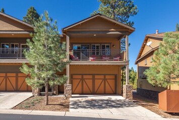 Front exterior showing 1 of 2 balconies. Parking for 4 cars.