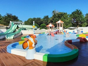 A water park with slides, a pool, and play structures.