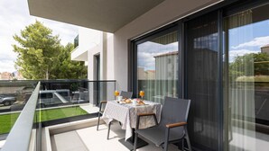 A balcony with a table set for breakfast, overlooking a cityscape. - Amazing apartment in Podstrana with WiFi (Podstrana)
