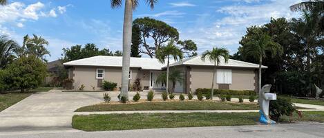A single-story house with a front yard, a driveway, and a mailbox.