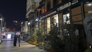 A multi-story building with balconies and a ground-level shop named "ALGOLD".