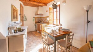 A cozy kitchen with a wooden table, chairs, and a stove.