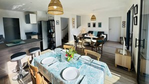 En moderne lejlighed med spiseplads, køkken og opholdsstue.