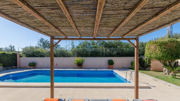 A swimming pool with lounge chairs and a pergola overhead. - Villa 'Viñas Ref 259' with Mountain Views, Private Pool and Wi-Fi (Son Servera)