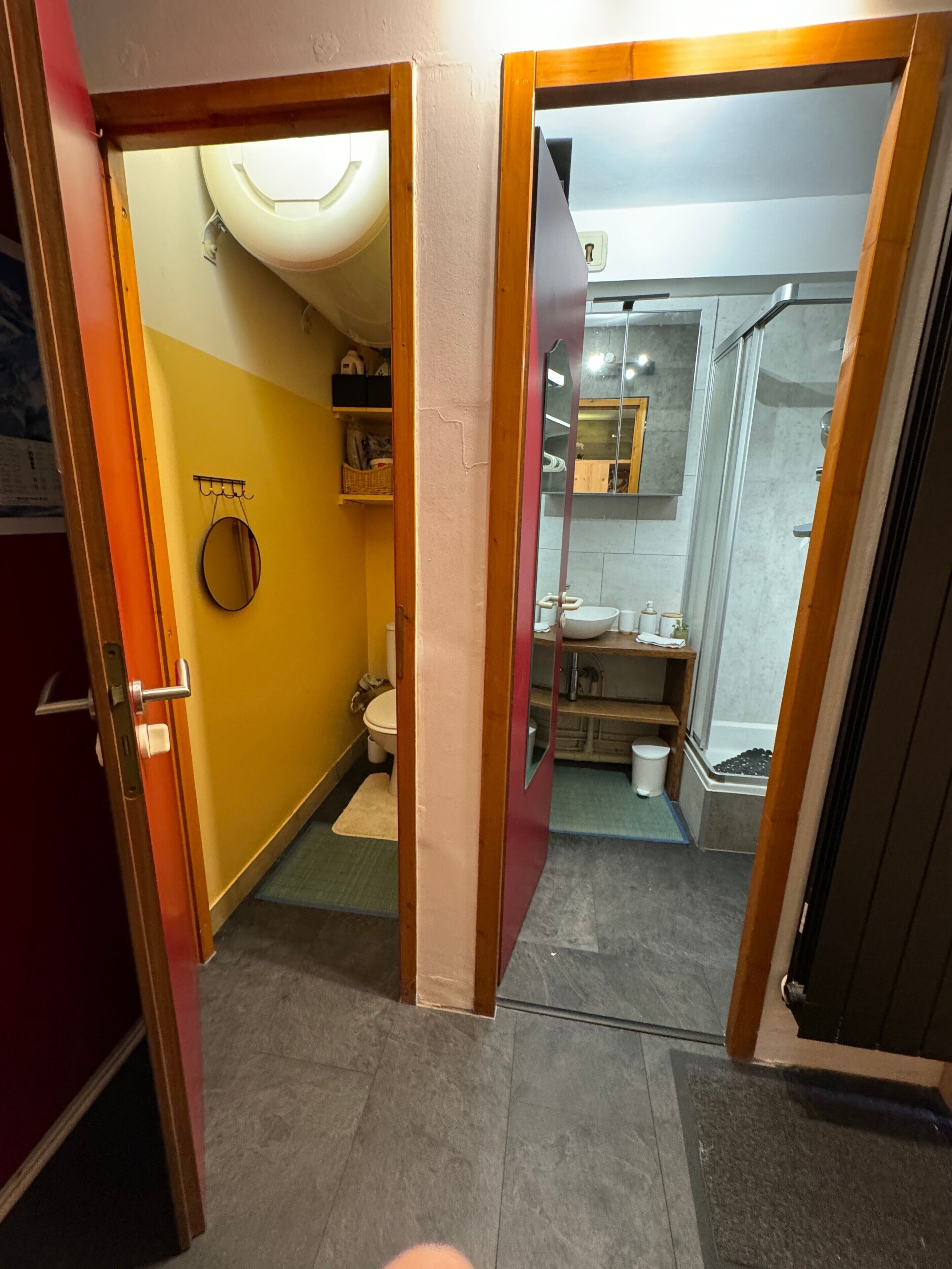 A bathroom with a toilet, sink, and shower area.