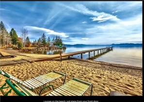 Relax on the beach with lounge chairs and enjoy the serene surroundings near a nearby park.