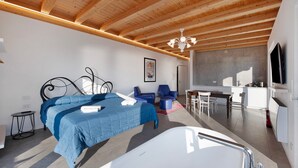 A modern bedroom with a large bed, a desk, and a television. - Studio 'Pai 521 Open Space' with Lake View, Wi-Fi and Air Conditioning (Torri del Benaco)