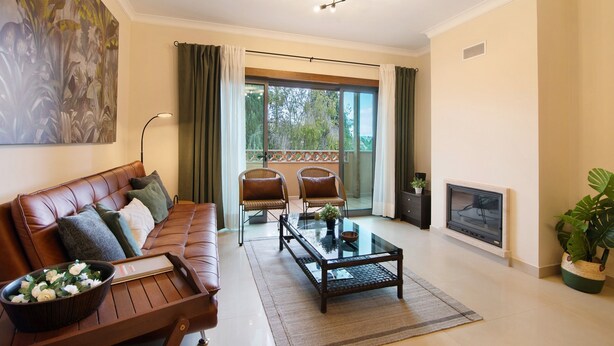 A living room with a sofa, two chairs, a coffee table, a fireplace, and a balcony with curtains. - Apartment 'Condomínio Do Vale' with Shared Pool, Shared Terrace and Wi-Fi (Guia)